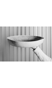 Arm outstretched holding large pie dish, handmade by Wonki Ware in South Africa, available at Amara Home.