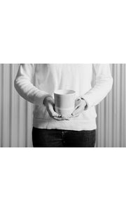 Person holding black wash Straight Mug, handmade by Wonki Ware in South Africa, available at Amara Home.